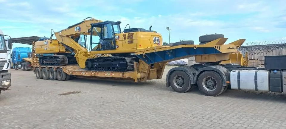 Escavadeira CAT acomodada em prancha para transporte especializado